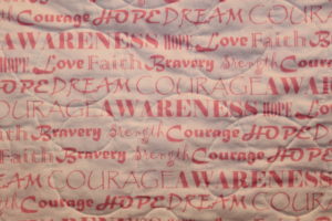 Breast Cancer Quilts - The back fabric of the Tender Hearts quilt is filled with inspirational words.